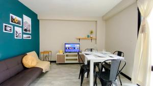 a living room with a table and a couch at Amanecer del Fuego III in Ushuaia