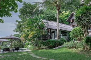 a house in the middle of a yard at Vikasa Yoga Retreat in Lamai