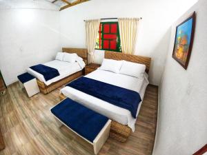 Postel nebo postele na pokoji v ubytování Casa Flórez Hotel Campestre