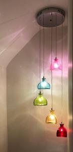 a group of lights hanging from a ceiling at Southwell Holiday Cottage - Lavender Cottage in Southwell