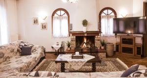 a living room with a couch and a fireplace at Georgia's GuestHouse in Kastoria