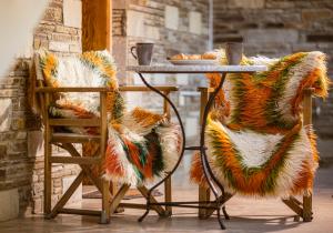 a table with two chairs and a table with food on it at Georgia's GuestHouse in Kastoria