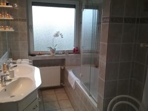 a bathroom with a tub and a sink and a shower at Urlaubs Oase in Telgte