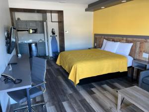 a hotel room with a bed and a kitchen at The Residency Suites in Sugar Land