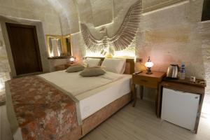 Postel nebo postele na pokoji v ubytování Mesken Cave Suites