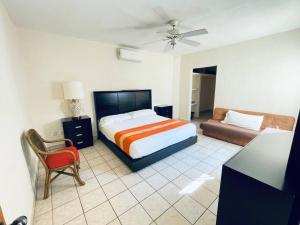 1 dormitorio con 1 cama y 1 sofá en Casa cerca del mar! 4 Habitaciones con aire acondicionado, en Puerto Vallarta