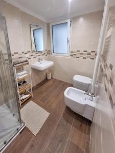 a bathroom with a sink and a toilet and a shower at SUITE GENTILE in Bari