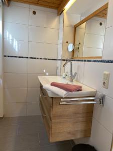 a bathroom with a sink and a mirror at Landhaus & Pension Christian in Füssen