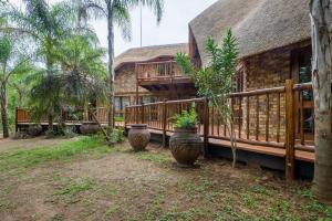 a house with three potted plants in front of it at Kruger Park Lodge Unit No. 221 in Hazyview
