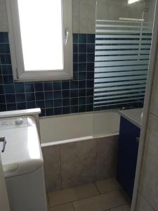 a bathroom with a tub and a sink and a window at Le Ker Bleu in Perros-Guirec +36 photos
