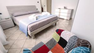 a bedroom with two beds and a couch in it at Chiara's Home in Brindisi