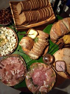 a table topped with lots of different types of food at Hotel Himmelblau Blumenau - Centro de Blumenau, próximo ao Neumarkt Shopping in Blumenau
