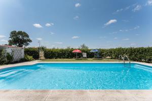 a swimming pool in a yard with a umbrella at Sevenfarm in Mangualde