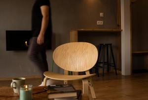 a person standing next to a chair in a room at Panorama / TinyHouse in Podbrezová