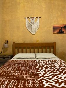 a bedroom with a bed with a black and white bedspread at Casa Tribus Itamambuca in Ubatuba