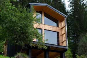 a house with a large window on top of a tree at Panorama / TinyHouse in Podbrezová