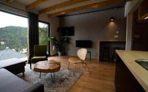 a living room with a couch and a table at Panorama / TinyHouse in Podbrezová