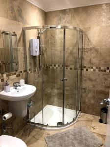 a bathroom with a shower and a sink at Sitwell coastal apartment with free parking in Scarborough