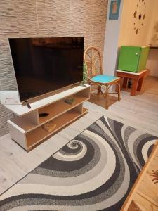 a living room with a large flat screen tv at AJ Studio Apartment in Moka