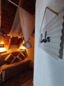 a bedroom with a bed in a room with a ceiling at Superbe Loft cocooning in Ustou