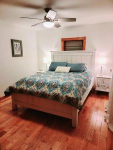 a bedroom with a bed and a ceiling fan at Hiking, MTB, four wheeling, fishing lakes, beaches, skiing, snowboarding, in Barton