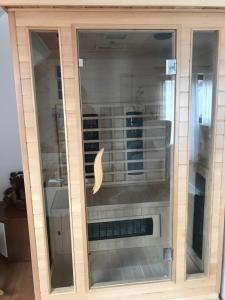 a large glass cabinet with a dishwasher in it at Apartman Bosco in Ravna Gora +23 photos