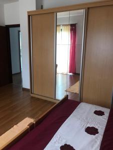 a bedroom with a bed and a large mirror at Apartman Bosco in Ravna Gora