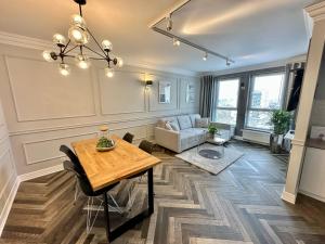 a living room with a table and a couch at LuxApart Kalisz V.I.P in Kalisz