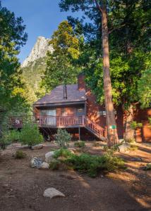a house with a deck in the middle of trees at Idyllwild Inn and Strawberry Creek Inn in Idyllwild