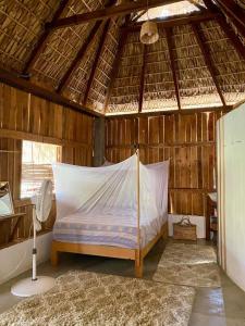 a bedroom with a bed with a mosquito net at Casa Aquila Mazunte in Mazunte