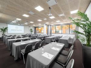 a conference room with tables and chairs and a screen at Montanyà in Seva +89 photos