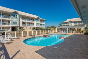 a swimming pool in front of a apartment complex at 200 yds to private gated beach access- 3BR-2BA- quiet location in the heart of Destin! in Destin