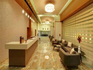 a lobby of a hotel with couches and a waiting room at Hotel Suba Elite Vadodara in Vadodara