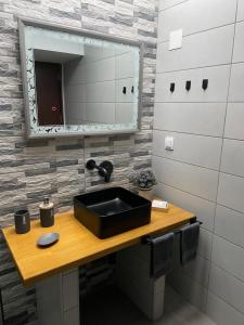 a bathroom with a sink and a mirror at Felicia`s House in Agria