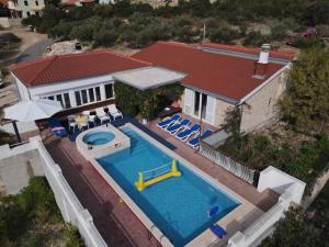 an aerial view of a house with a swimming pool at Villa Lucia with private pool and a whirlpool in Vis