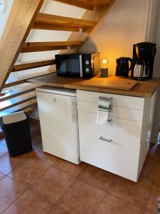 a kitchen with a microwave on top of a counter at Central floor with sauna, wi-fi and own entrance in Mariehamn