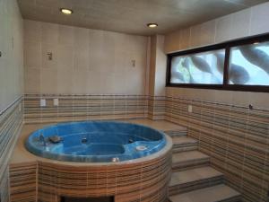 a large bathroom with a large blue tub at Gran México in Mexico City