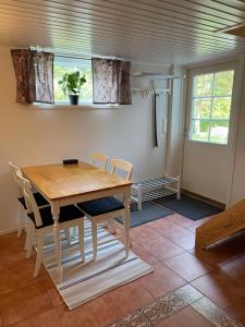 a dining room with a wooden table and chairs at Central floor with sauna, wi-fi and own entrance in Mariehamn