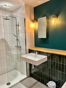 a bathroom with a sink and a shower at SoHot Stays Sea View Apartments in Kent