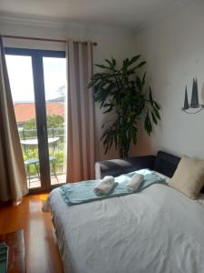 a bedroom with a bed with two towels on it at Amazing SEA LIGHT Apartment, close to the beach. in Santa Cruz