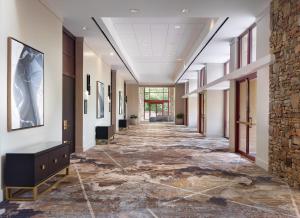 a hallway in a building with a stone floor at Emory Conference Center Hotel in Atlanta