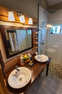 a bathroom with two sinks and a shower at Bjørn Holm in Port Renfrew