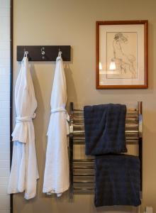 a bathroom with towels on a rack and a mirror at Bjørn Holm in Port Renfrew