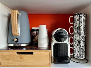a coffee maker and other items on a shelf at F3 Centre- Ville Lafayette avec garage in Clermont-Ferrand