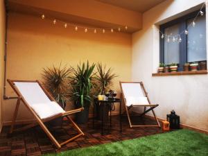 two chairs and a table on a patio with plants at My place in Cotillo 6 in El Cotillo