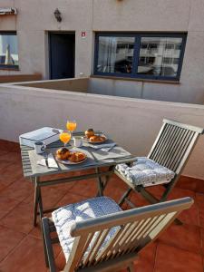 a table and two chairs with plates of food on it at My place in Cotillo 6 in El Cotillo +23 photos