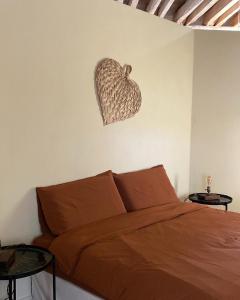 a bedroom with a bed and a basket on the wall at Il Casias in Balme