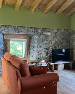 a living room with a couch and a tv at Il Casias in Balme