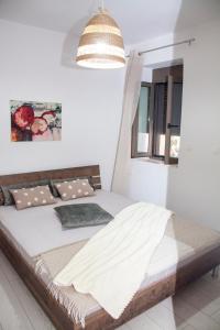 a bedroom with a bed in a white room at Aelia in Agios Vlasios