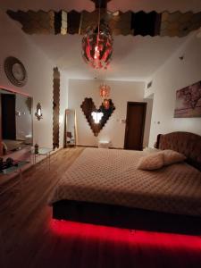 a bedroom with a large bed with a heart on the wall at Creekview Luxury Apartment in Ajman 